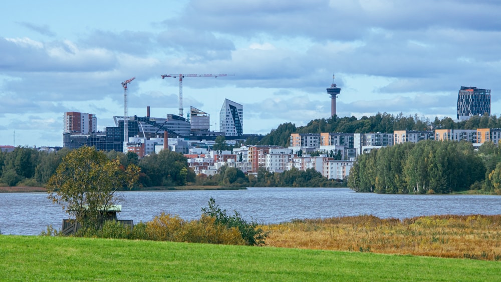 a view of a city with a lake in the foreground