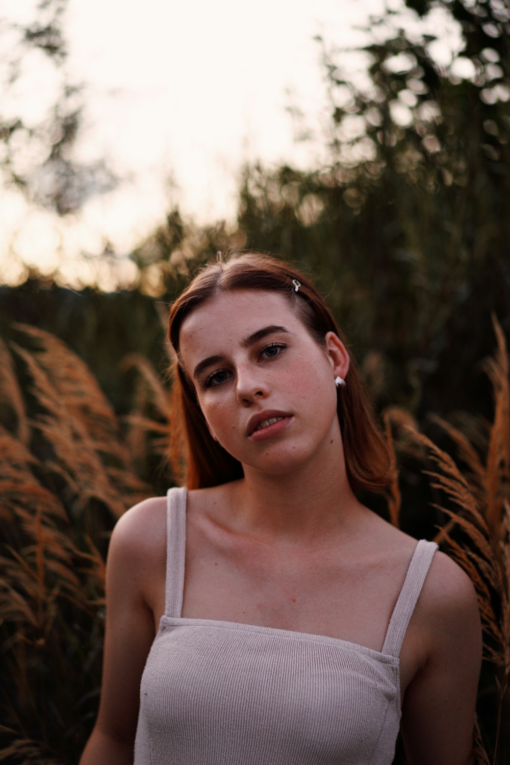 a woman standing in a field of tall grass