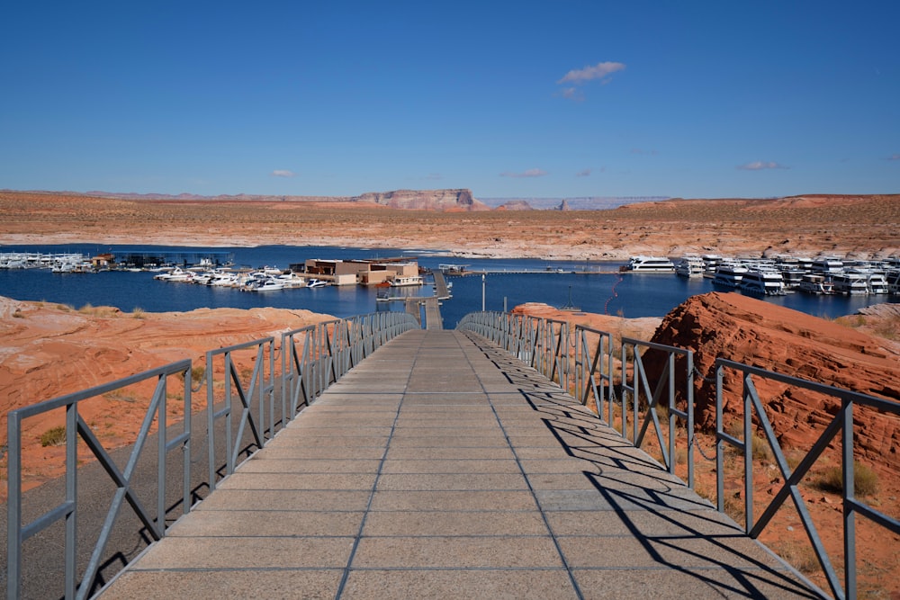 a walkway leading to a marina with boats in the water