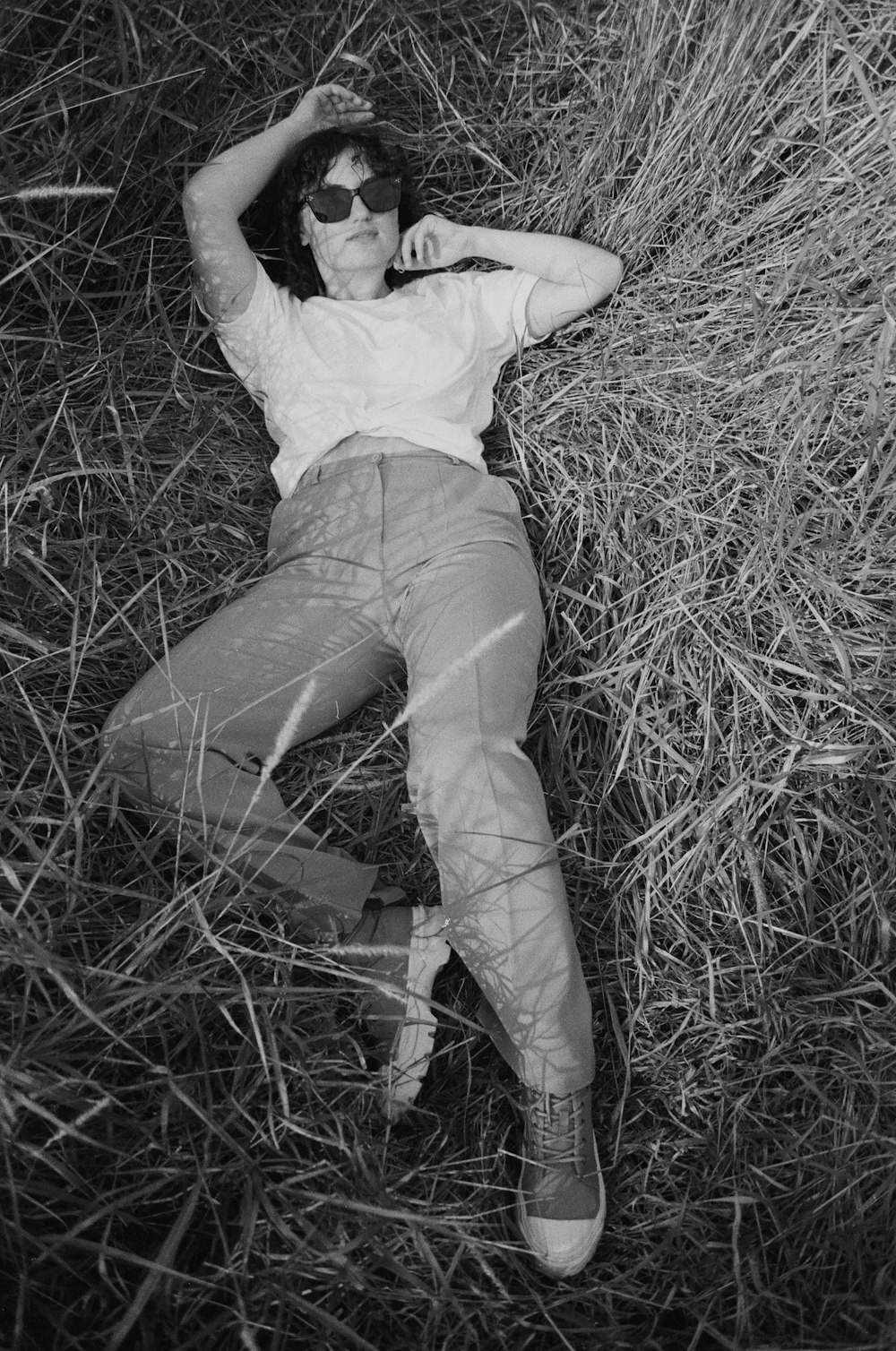 a man laying on the ground in a field
