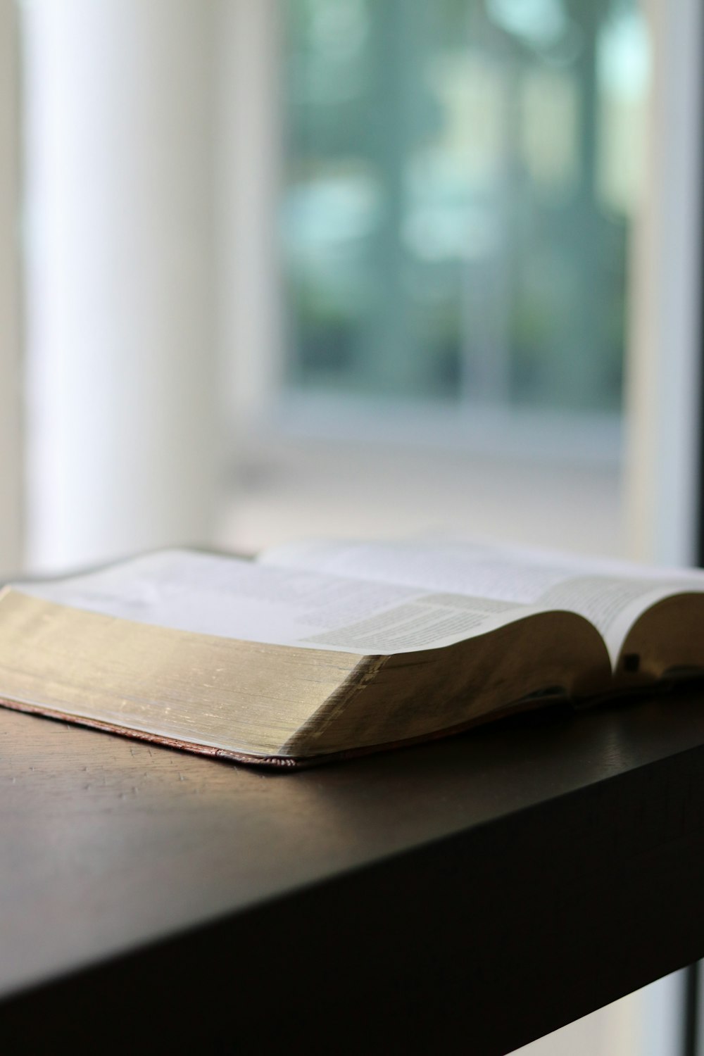 an open book sitting on top of a wooden table