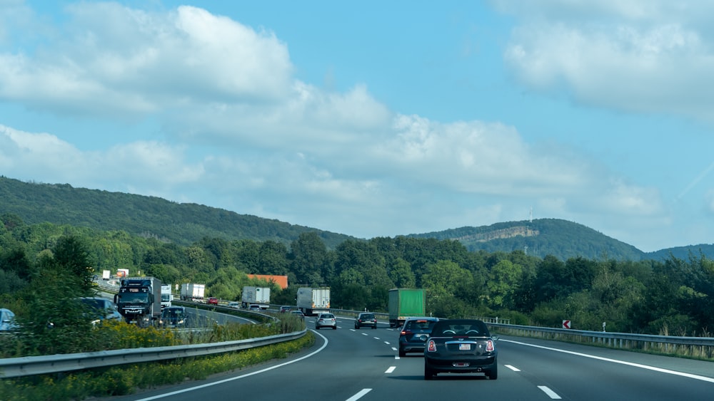 a couple of cars driving down a highway