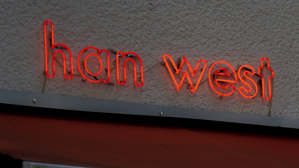 a neon sign on the side of a building