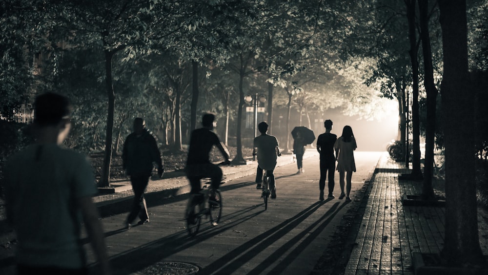 a group of people riding bikes down a street