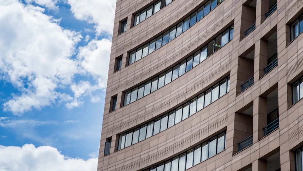 a tall building with lots of windows and a sky background