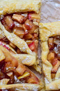 Close-up of a golden, flaky Danish apple tart with glistening caramelized apples on top