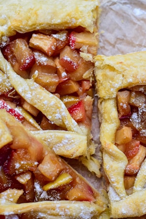 A close-up of a flaky tart filled with seasonal fruits.