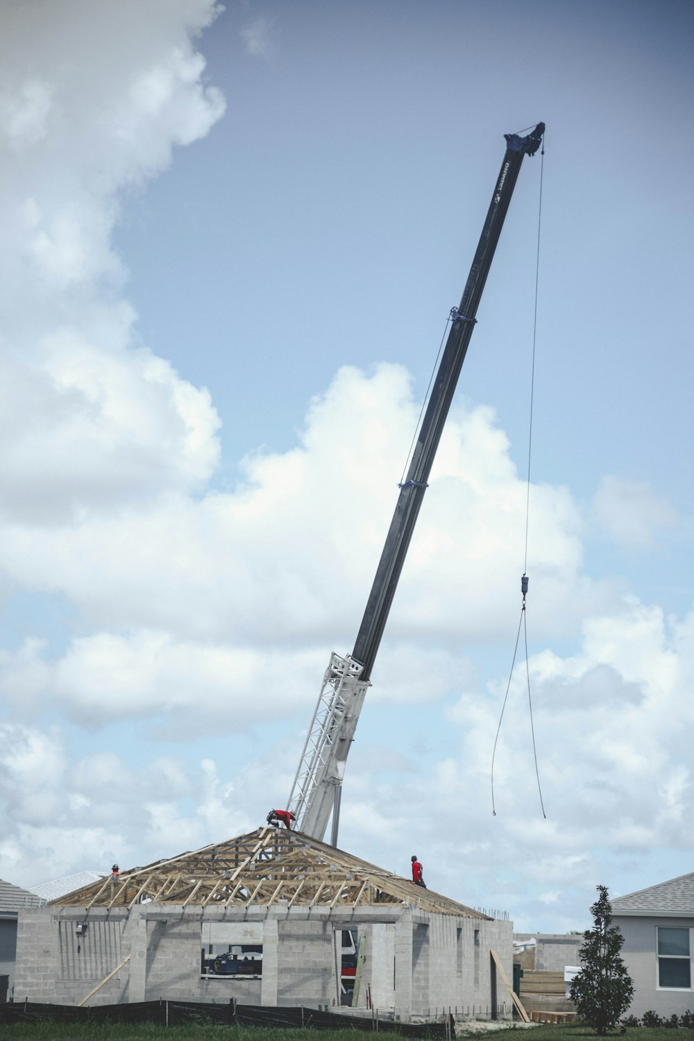 a crane is lifting a house into the air