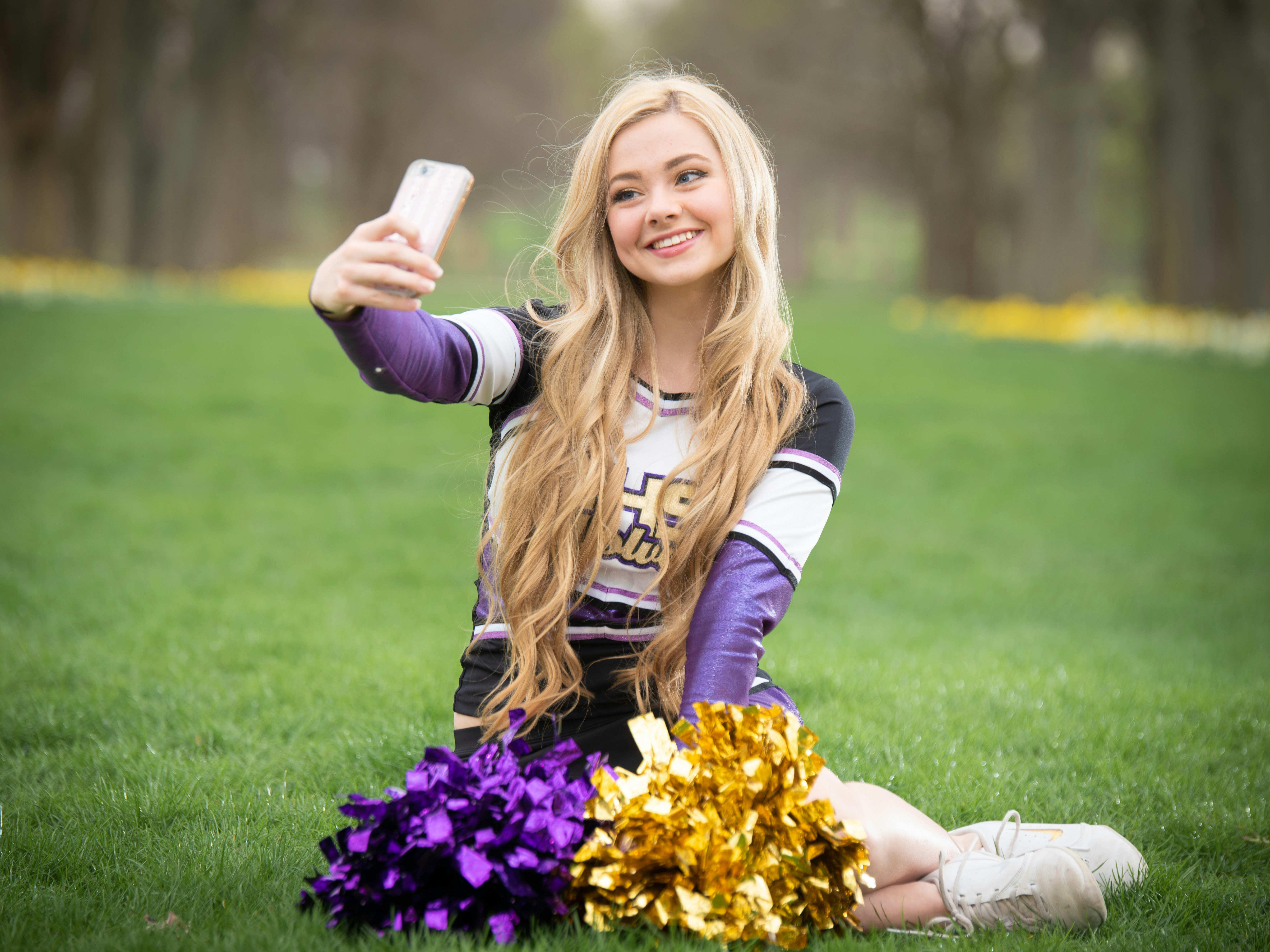 High School Cheerleader Taking a Selfie with a Smartphone