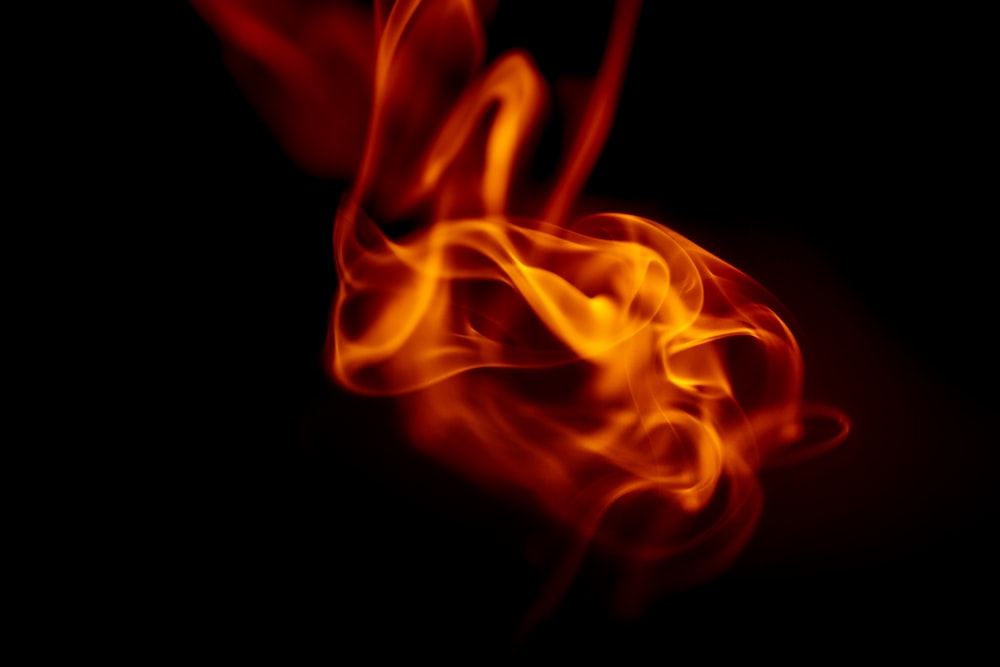 a close up of a red fire on a black background