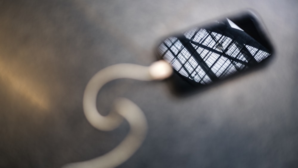 a close up of a mirror on a metal surface