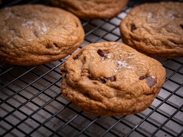 Chocolate chip cookies cooling on a wire rack