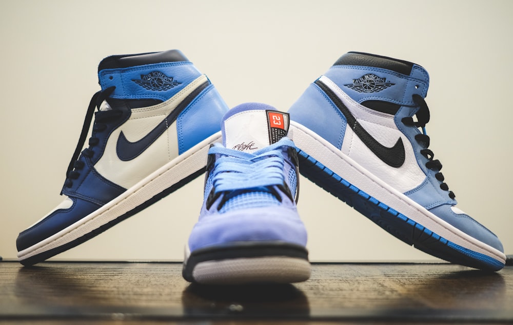 a pair of sneakers sitting on top of a wooden table