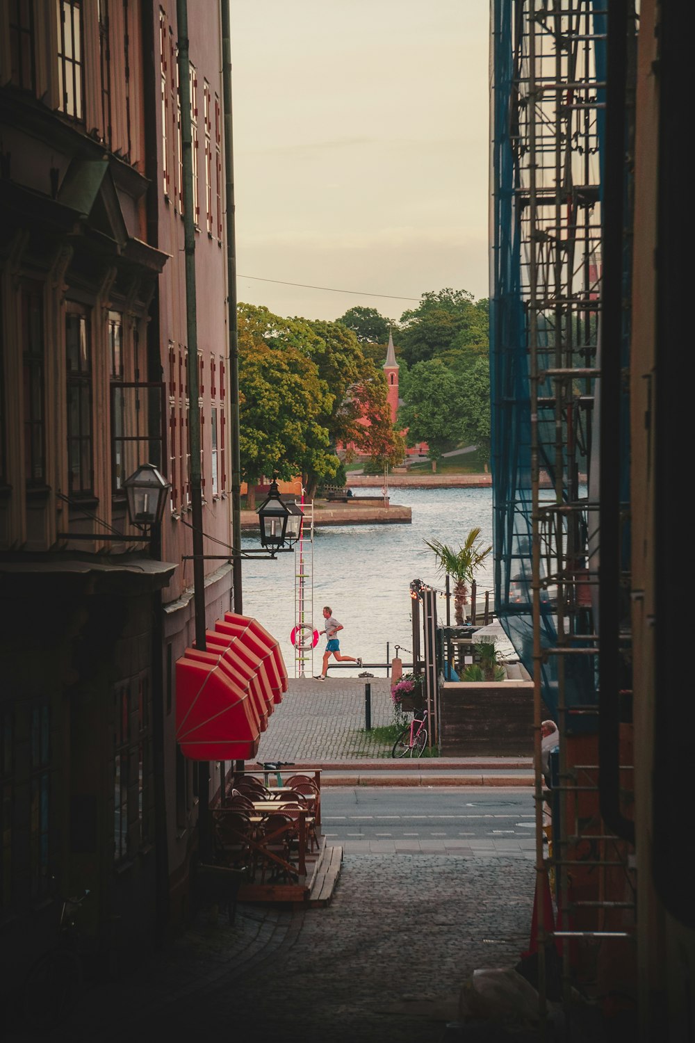 a red umbrella sitting on the side of a building