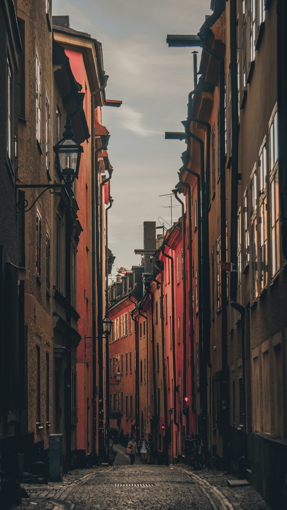 a narrow city street lined with tall buildings