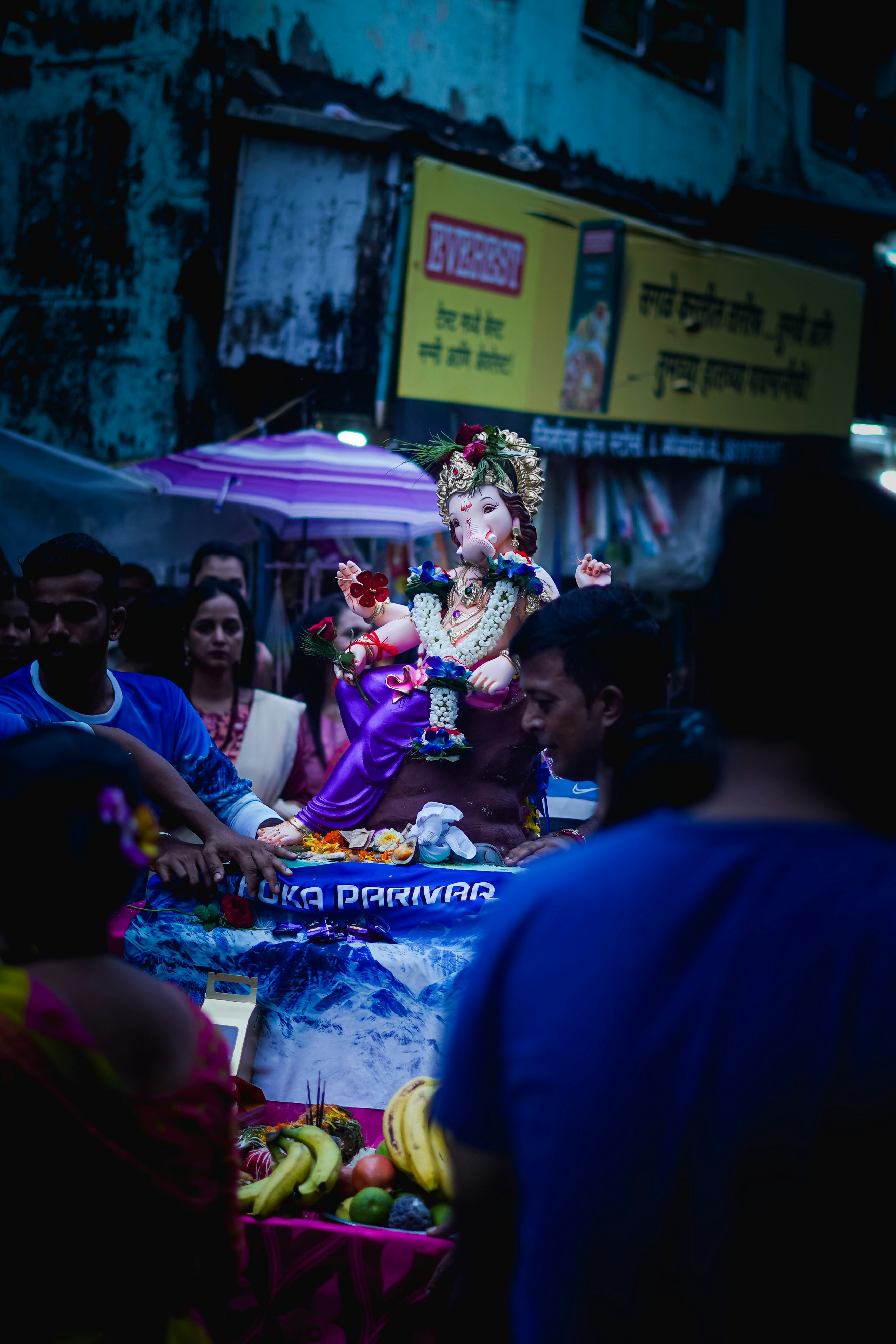 a group of people standing around a table with a statue on it