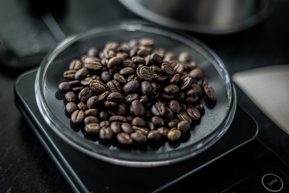 a glass plate filled with coffee beans on top of a stove