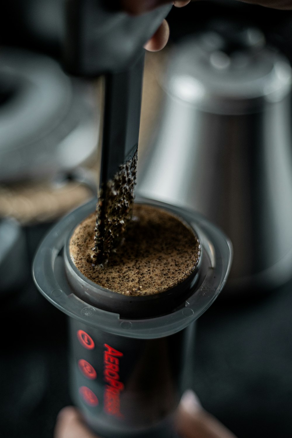 a person holding a blender filled with coffee