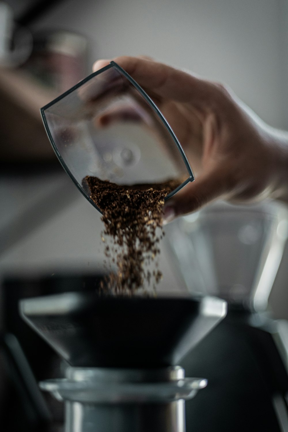 a person pouring coffee into a blender