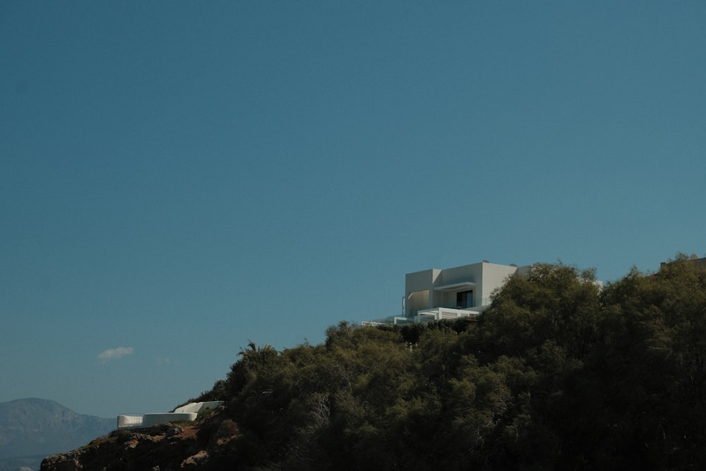 a house on top of a hill surrounded by trees