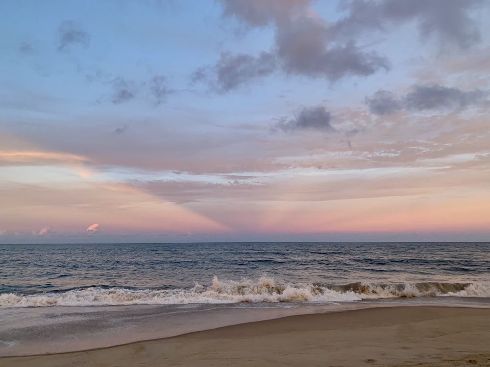 a beach with waves coming in to the shore