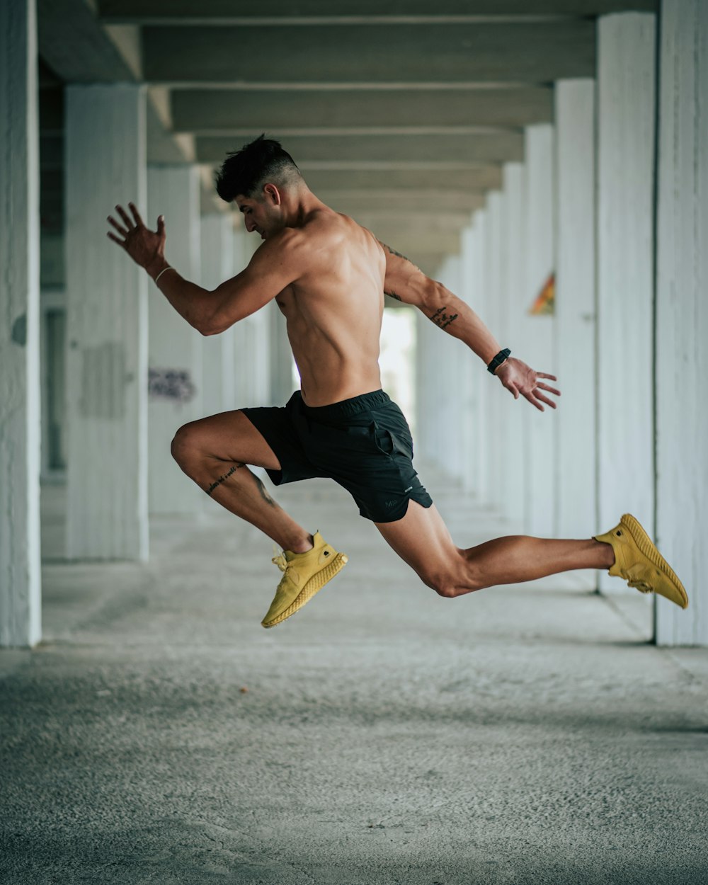 a shirtless man is jumping in the air