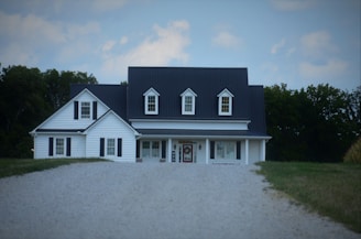 a large white house with a black roof
