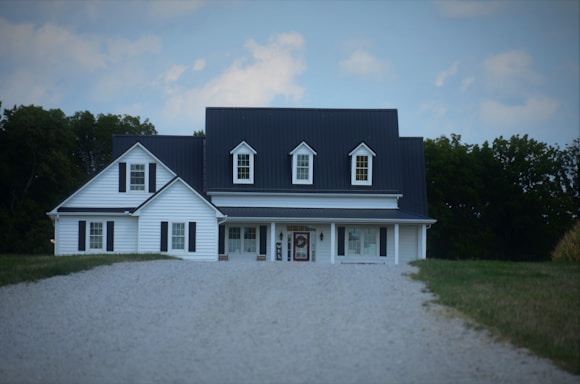 a large white house with a black roof