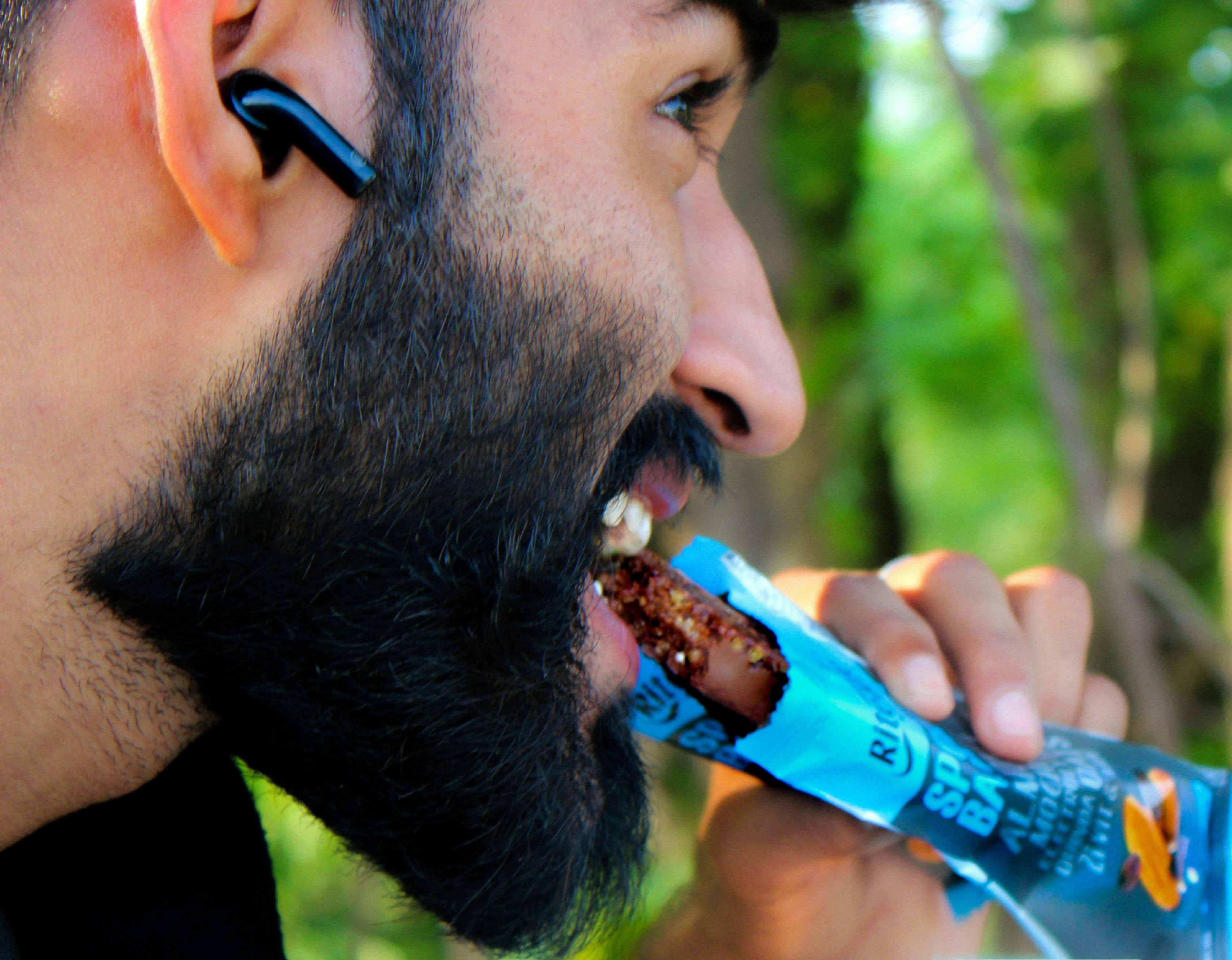 a man brushing his teeth with an electric toothbrush