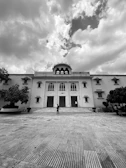 The grand entrance of étoile académie, showcasing its prestigious architecture under a bright blue sky.