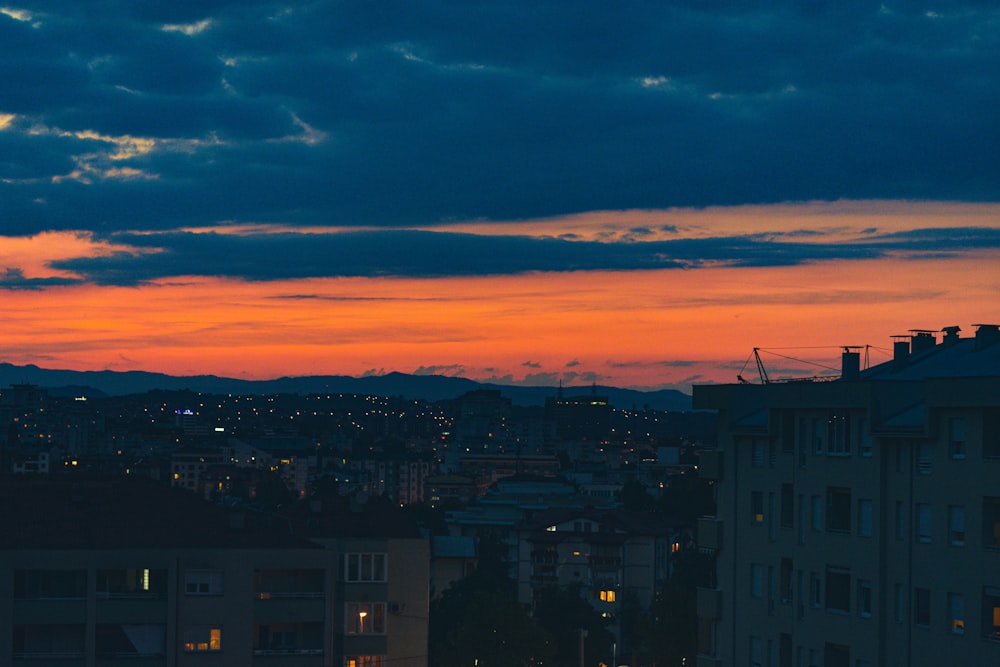 a view of a city at sunset from a rooftop