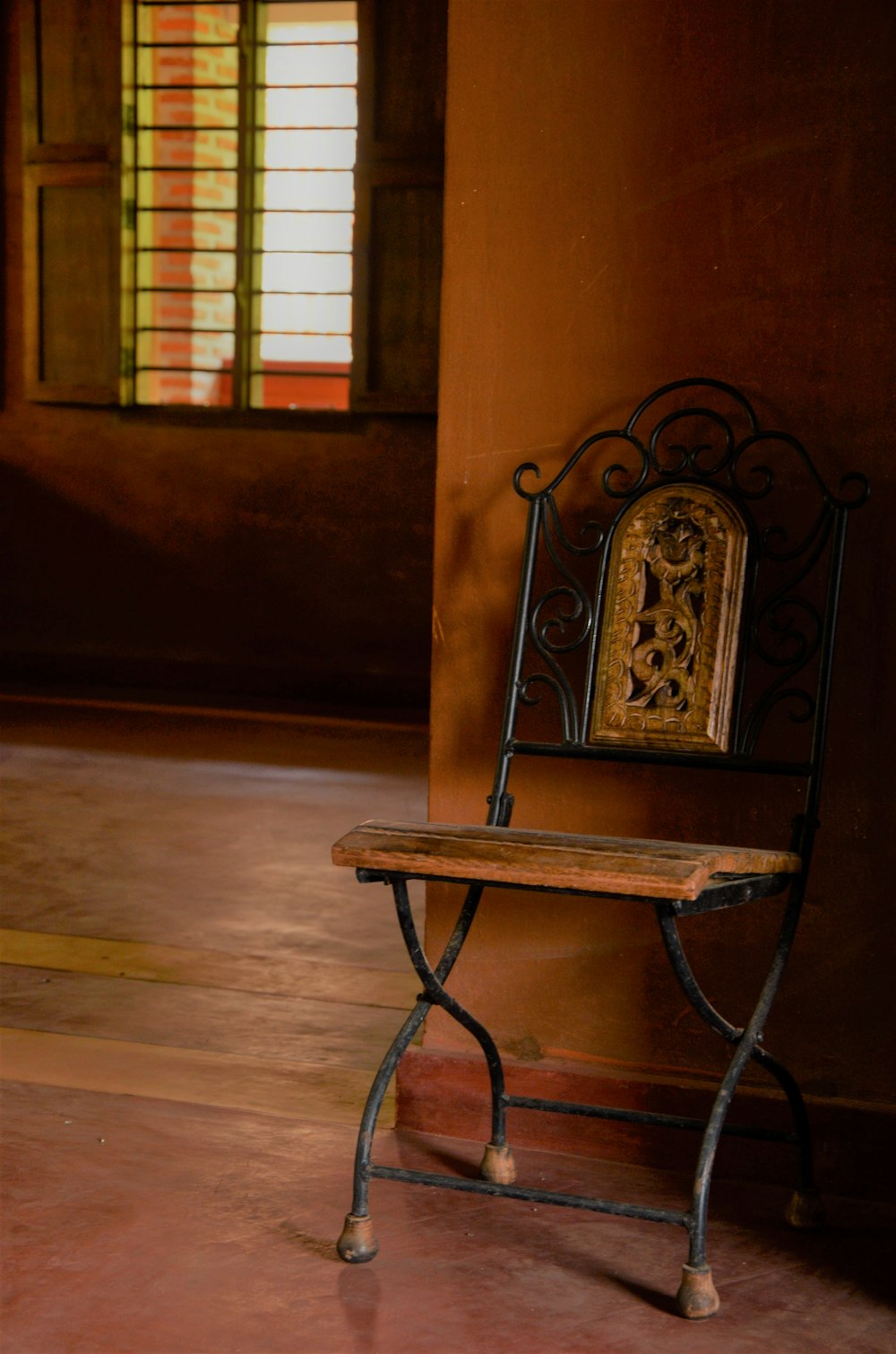 a bench sitting in a room next to a window