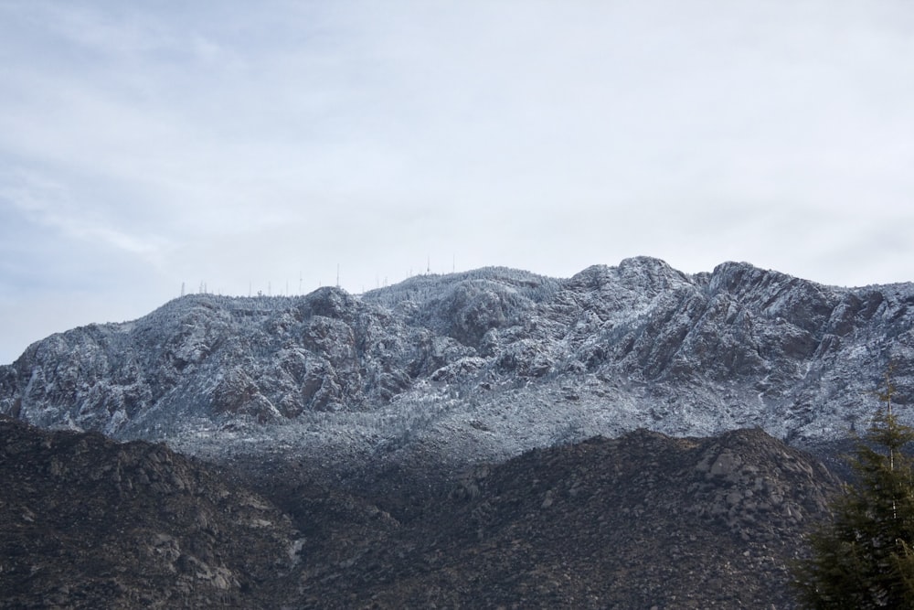 a mountain covered in snow with trees in the foreground