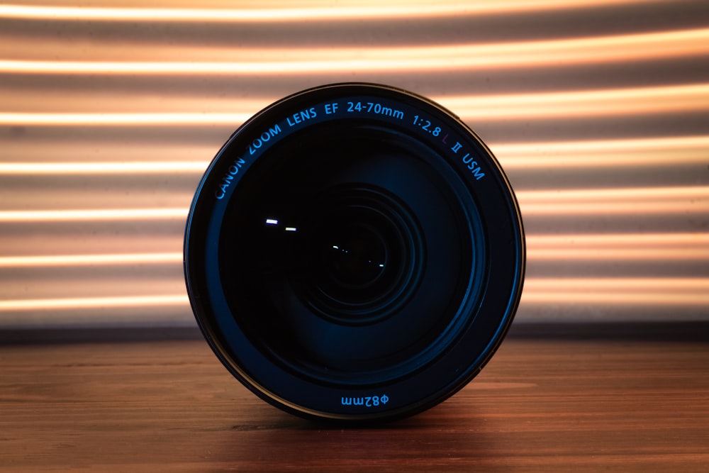 a camera lens sitting on top of a wooden table