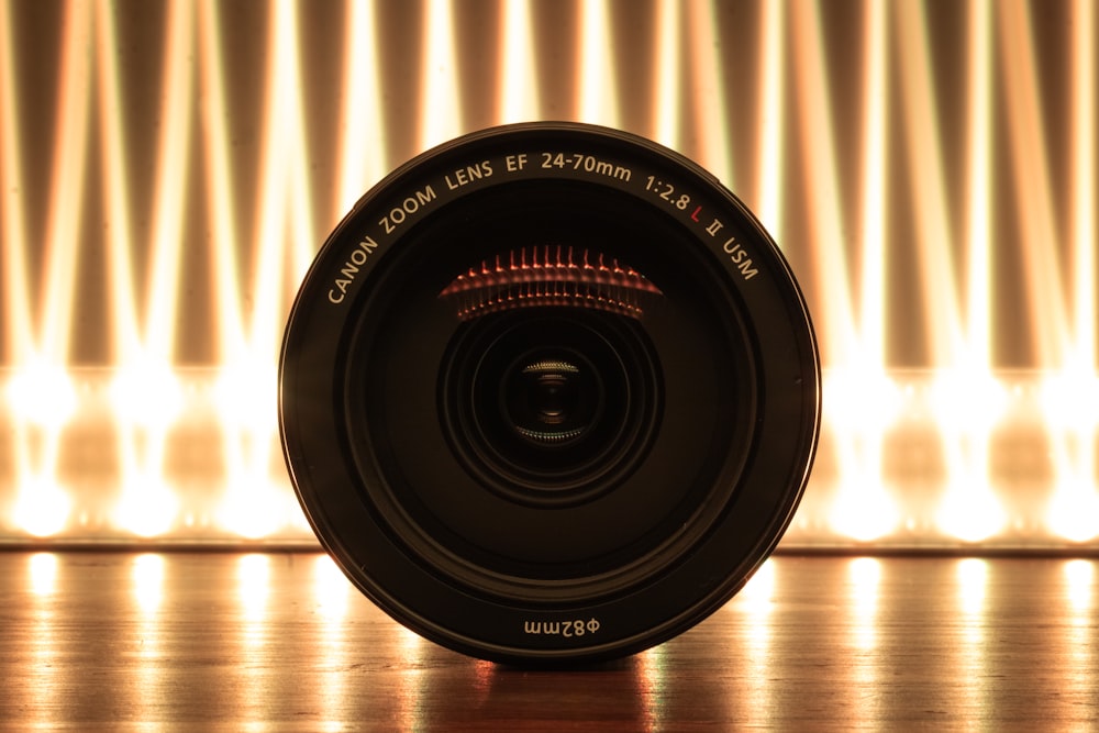 a camera lens sitting on top of a wooden table