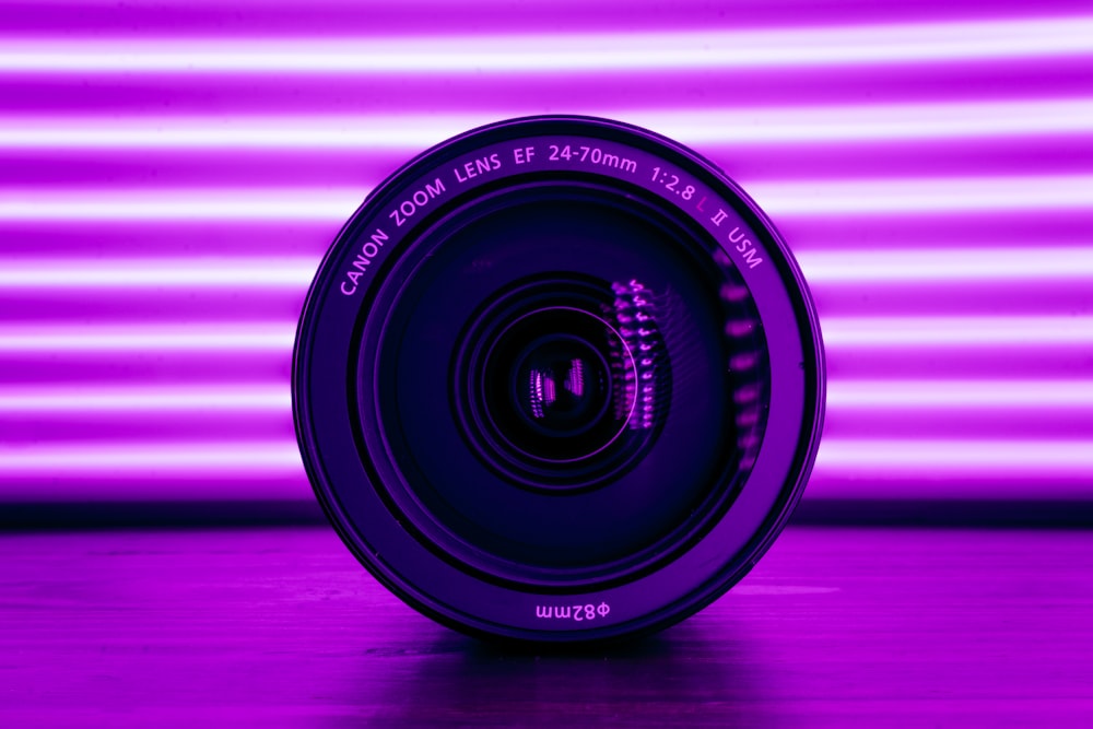 a camera lens sitting on top of a wooden table