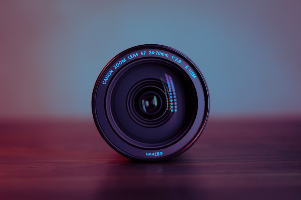 a camera lens sitting on top of a wooden table