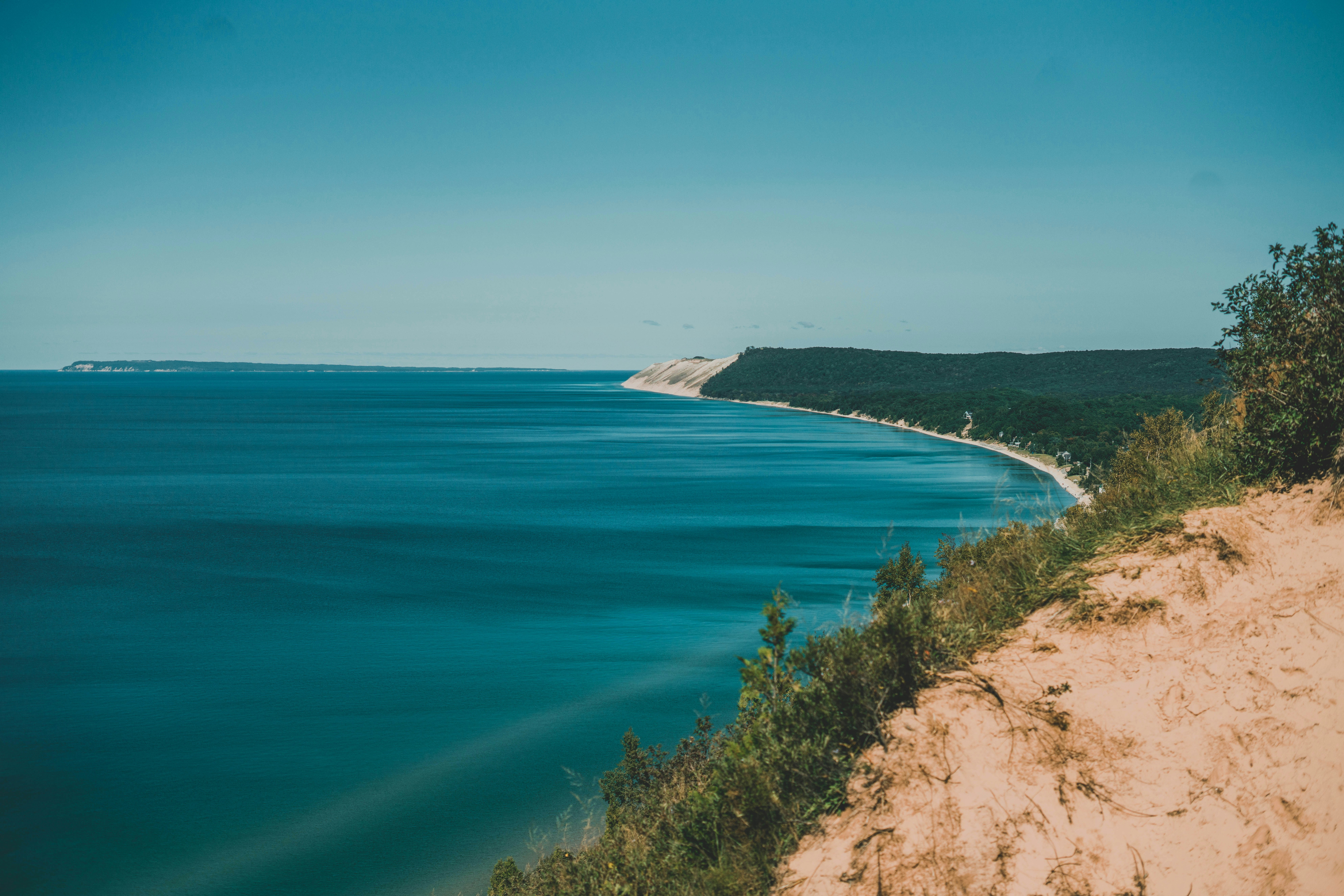 a view of a body of water from a cliff, 