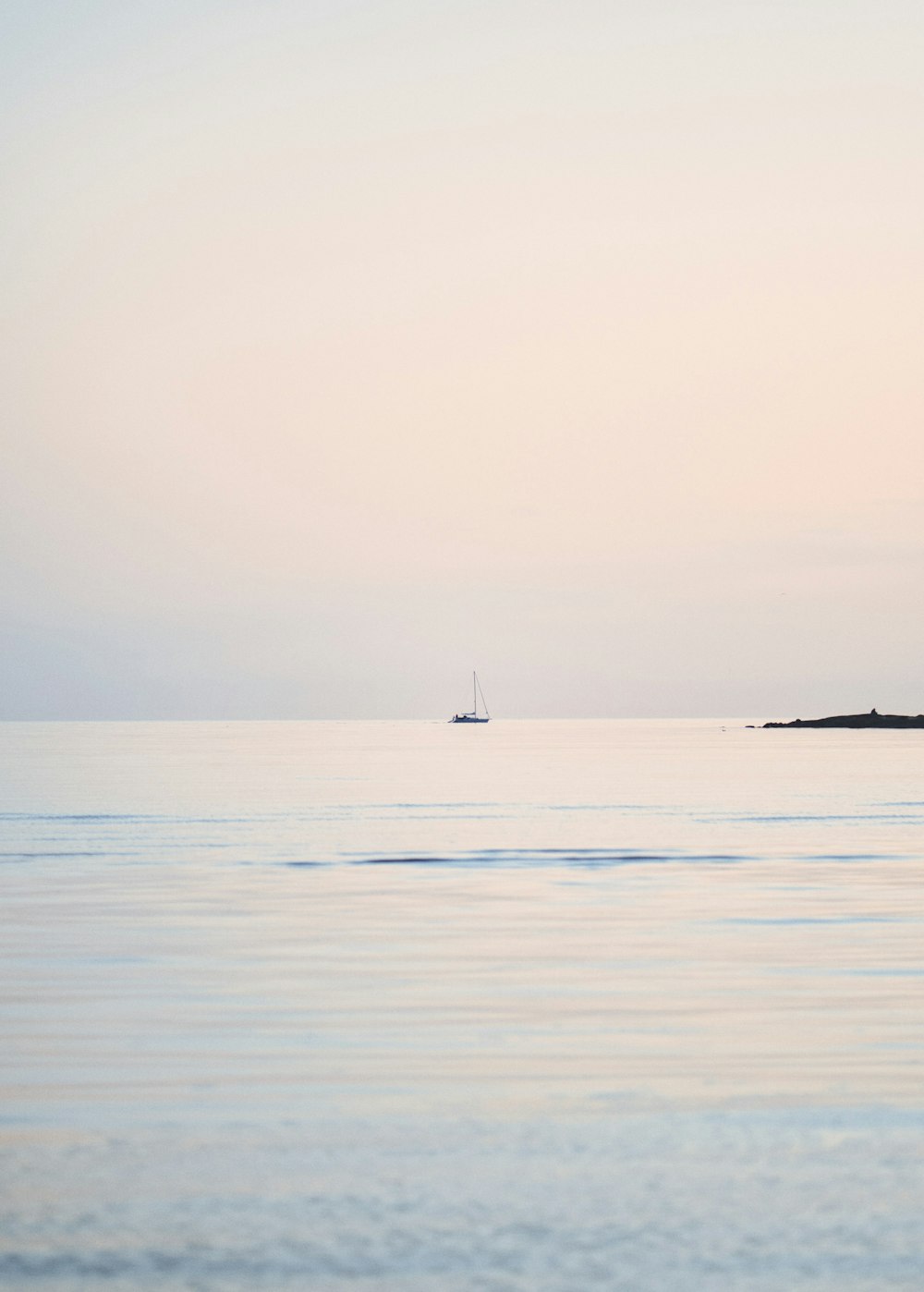 a boat is out on the water at sunset