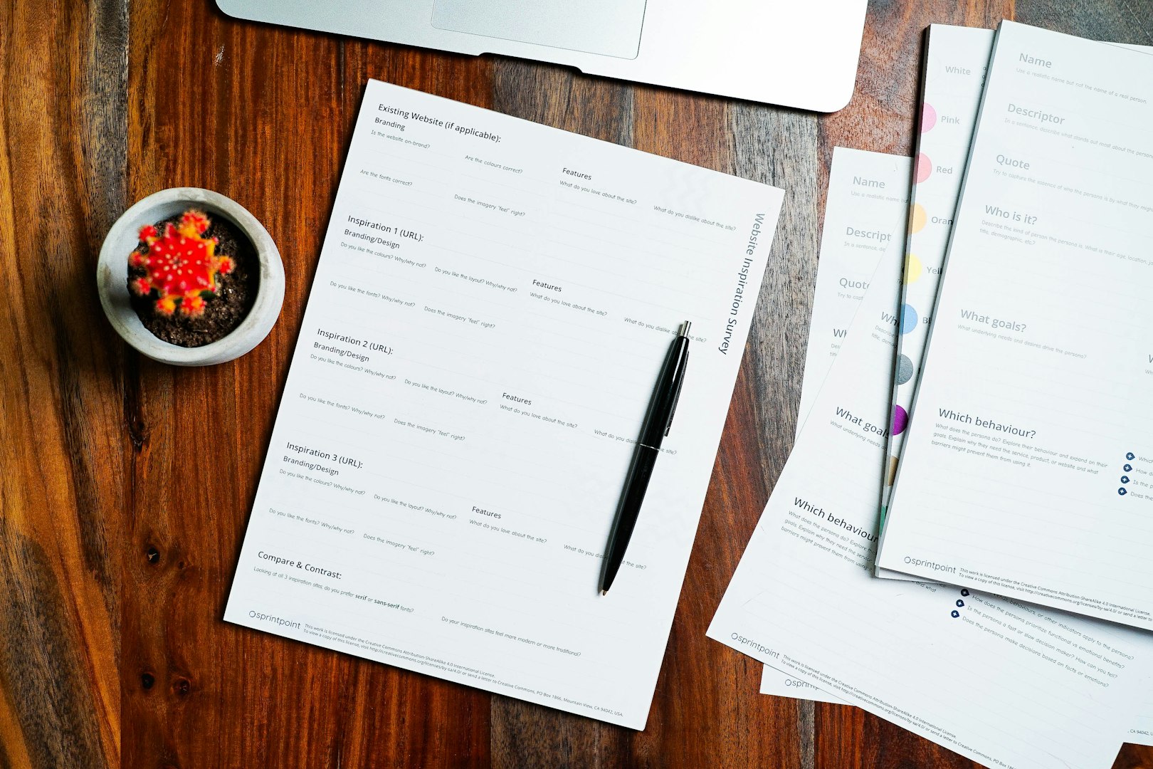 Printed application form and pen on a wooden table