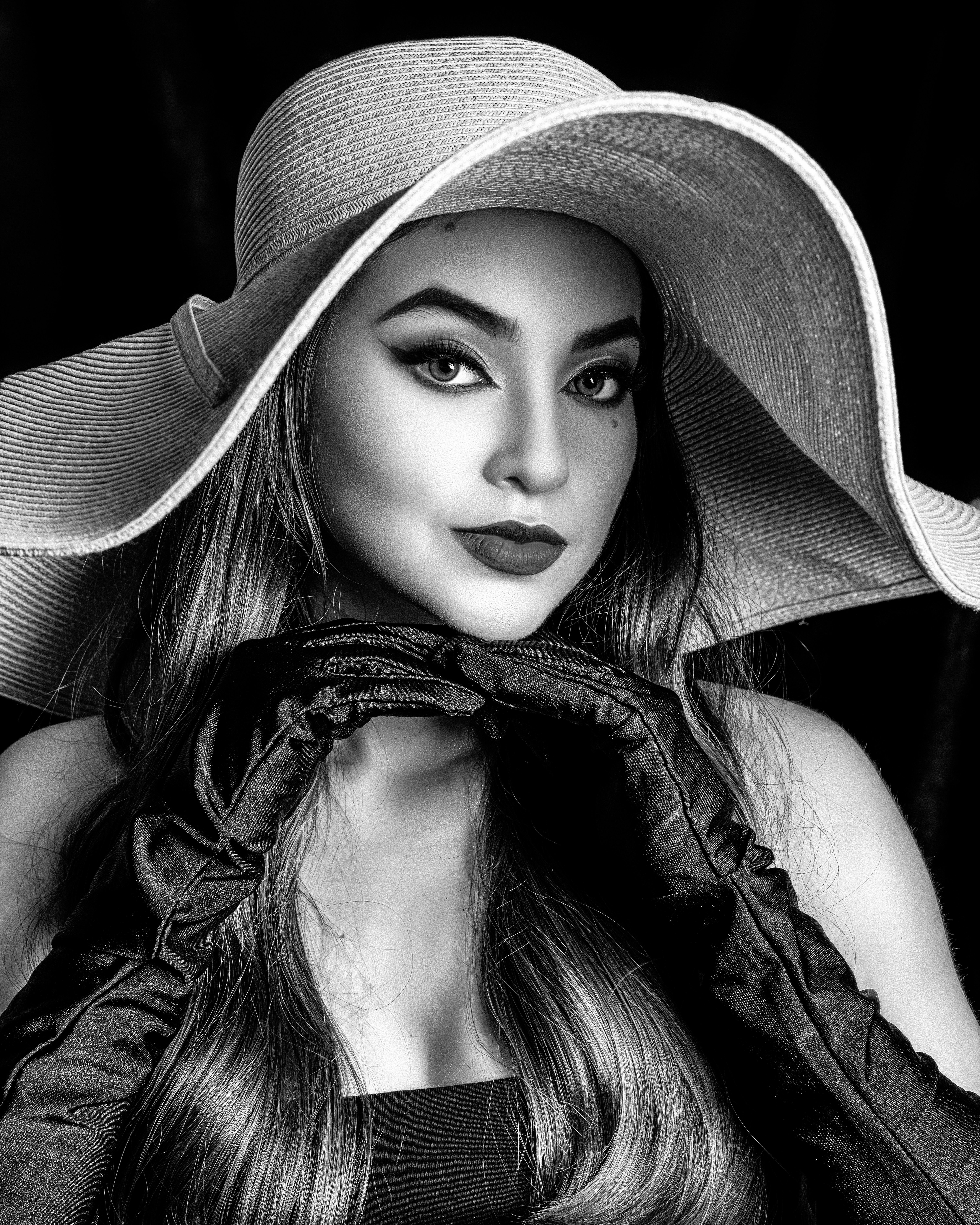 a woman wearing a large hat with long hair