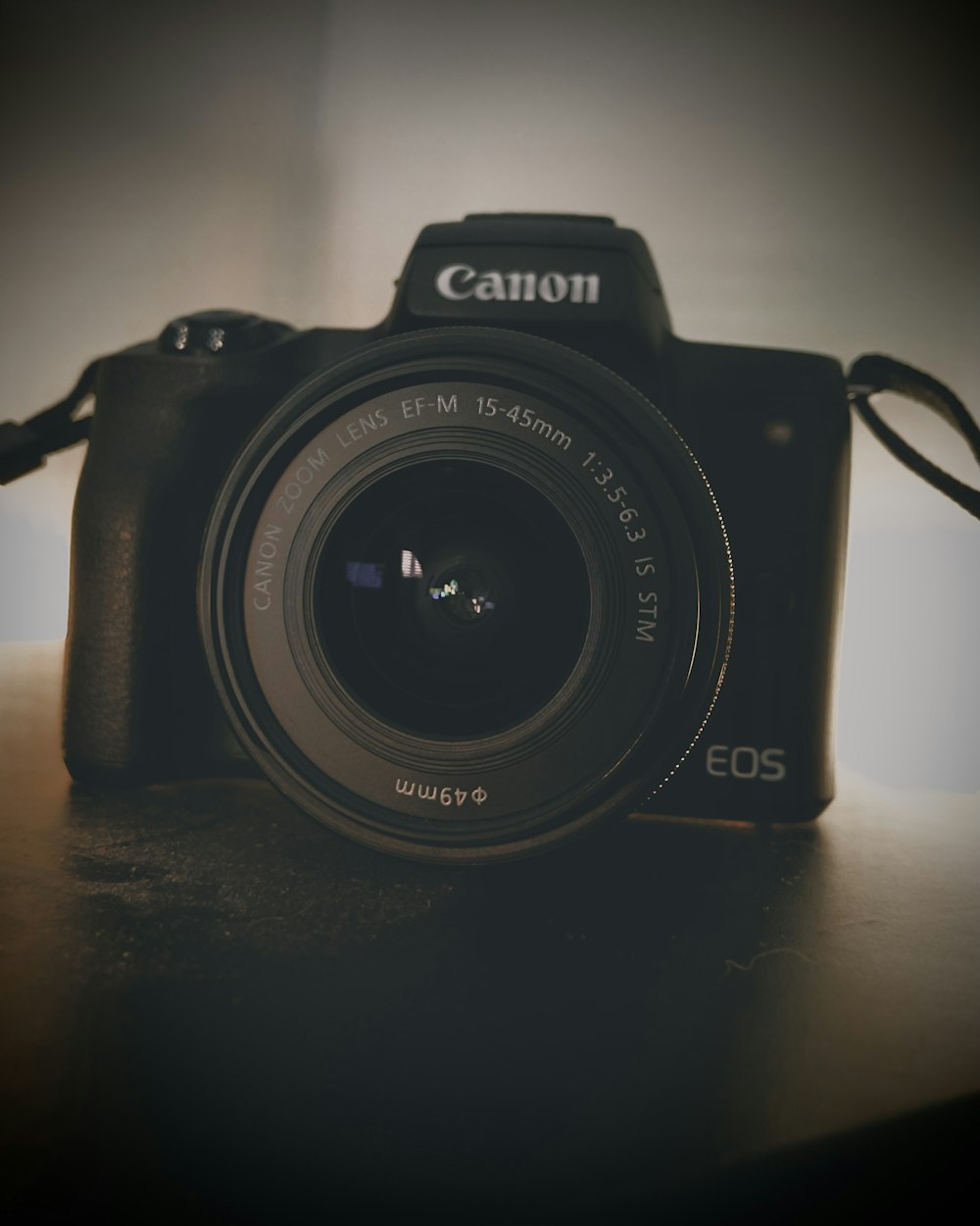 a black camera sitting on top of a wooden table