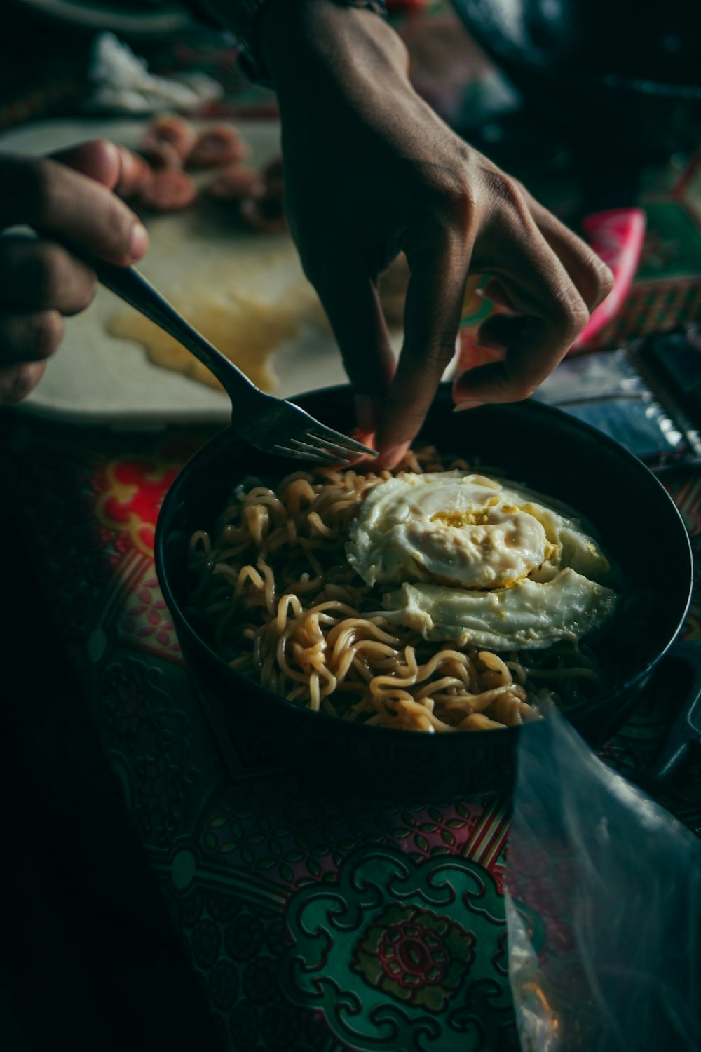 a bowl of noodles is being served with a fork