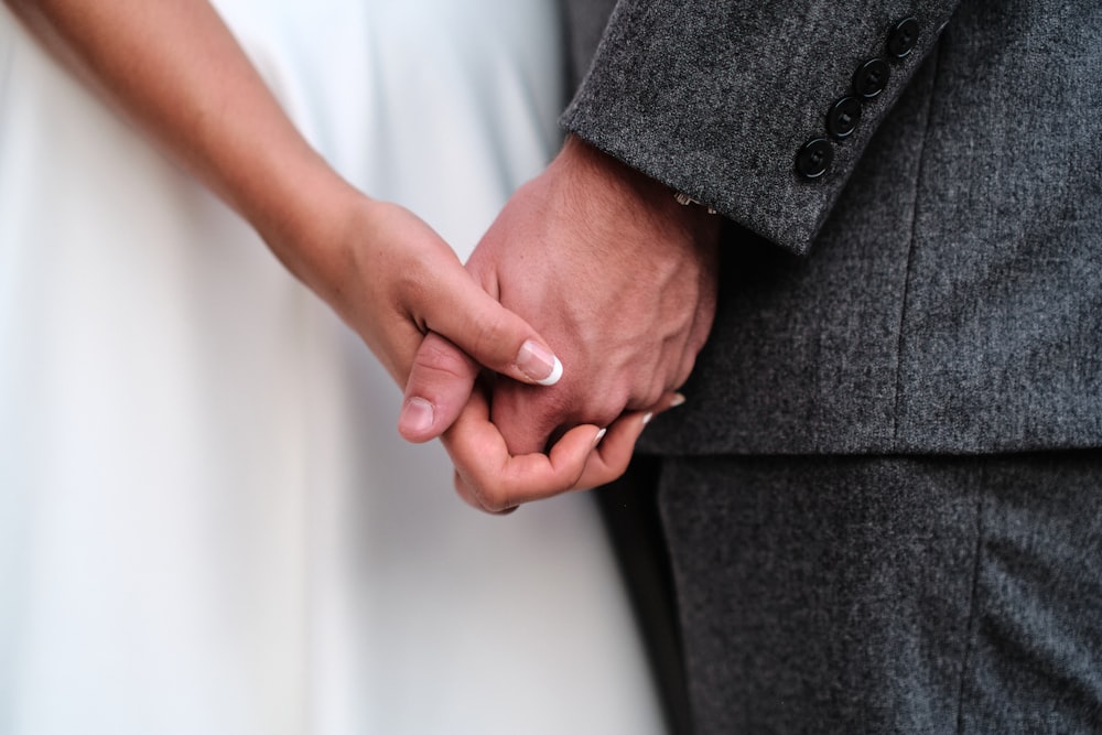 a close up of a person holding the hand of a person