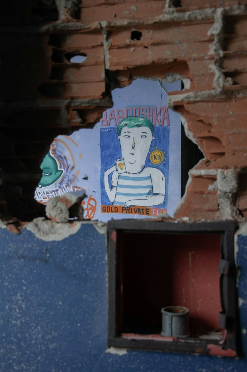 a hole in a wall with a picture of a man on it