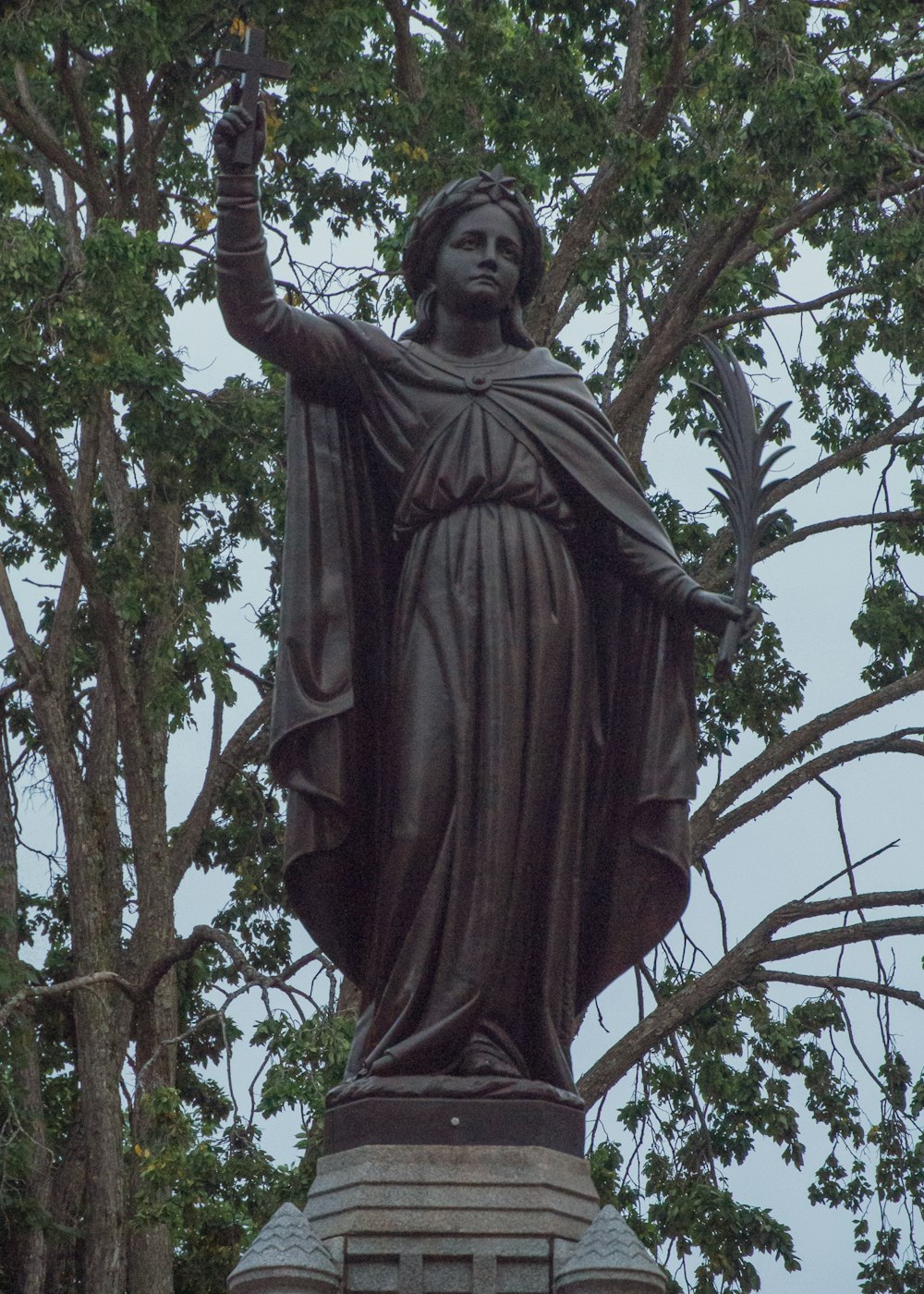 a statue of a woman with a bird in her hand