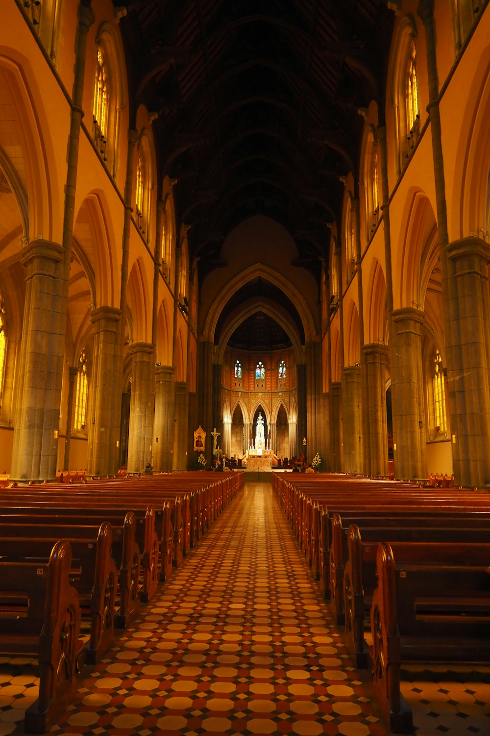 a church with rows of pews and a checkered floor