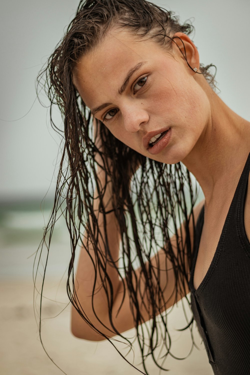 a woman with wet hair on the beach