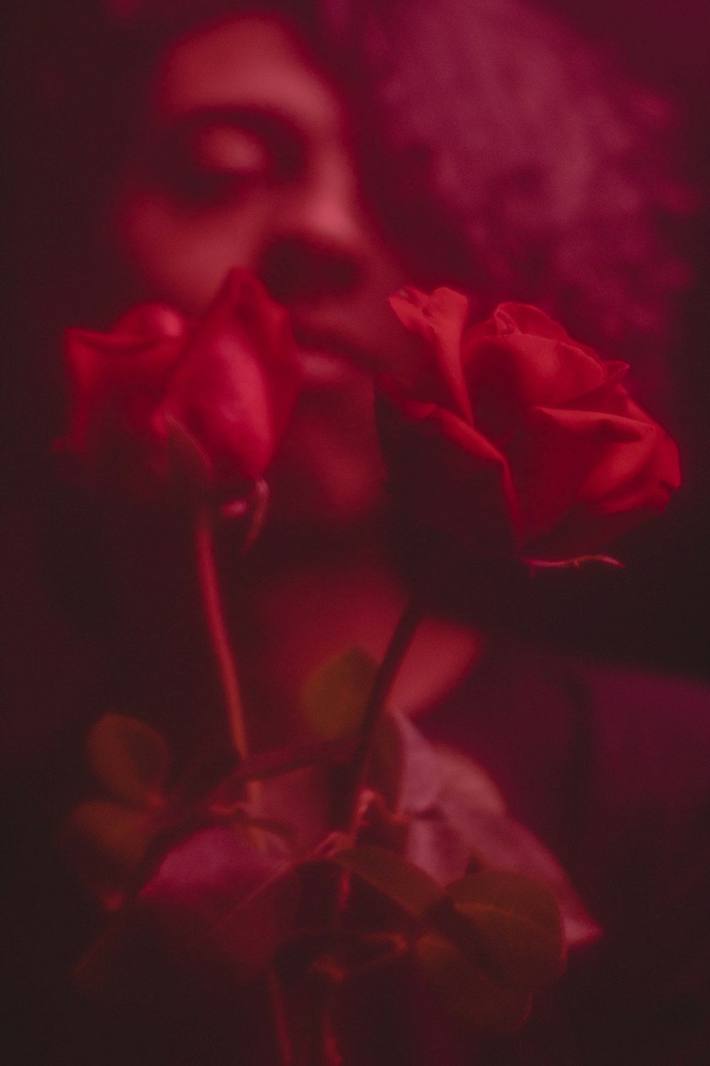 a close up of a person holding two roses