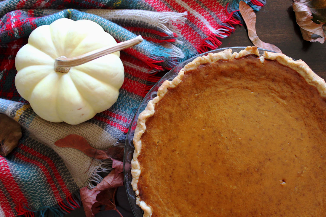 A whole pumpkin pie on a table